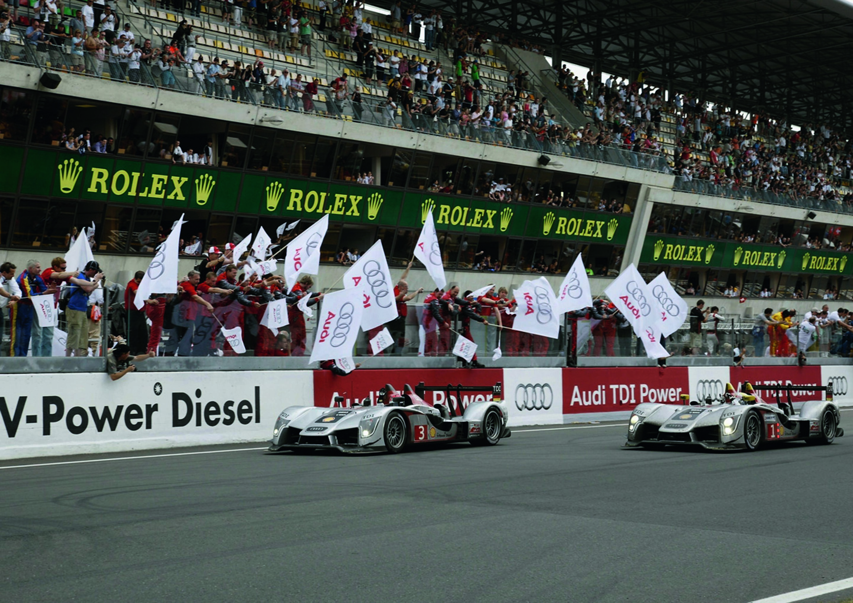 Anniversary magazine Motorsports - Le Mans 2009 - Sunday, just after 3.00 - both surviving Audi R15 TDIs cross the finish line together.