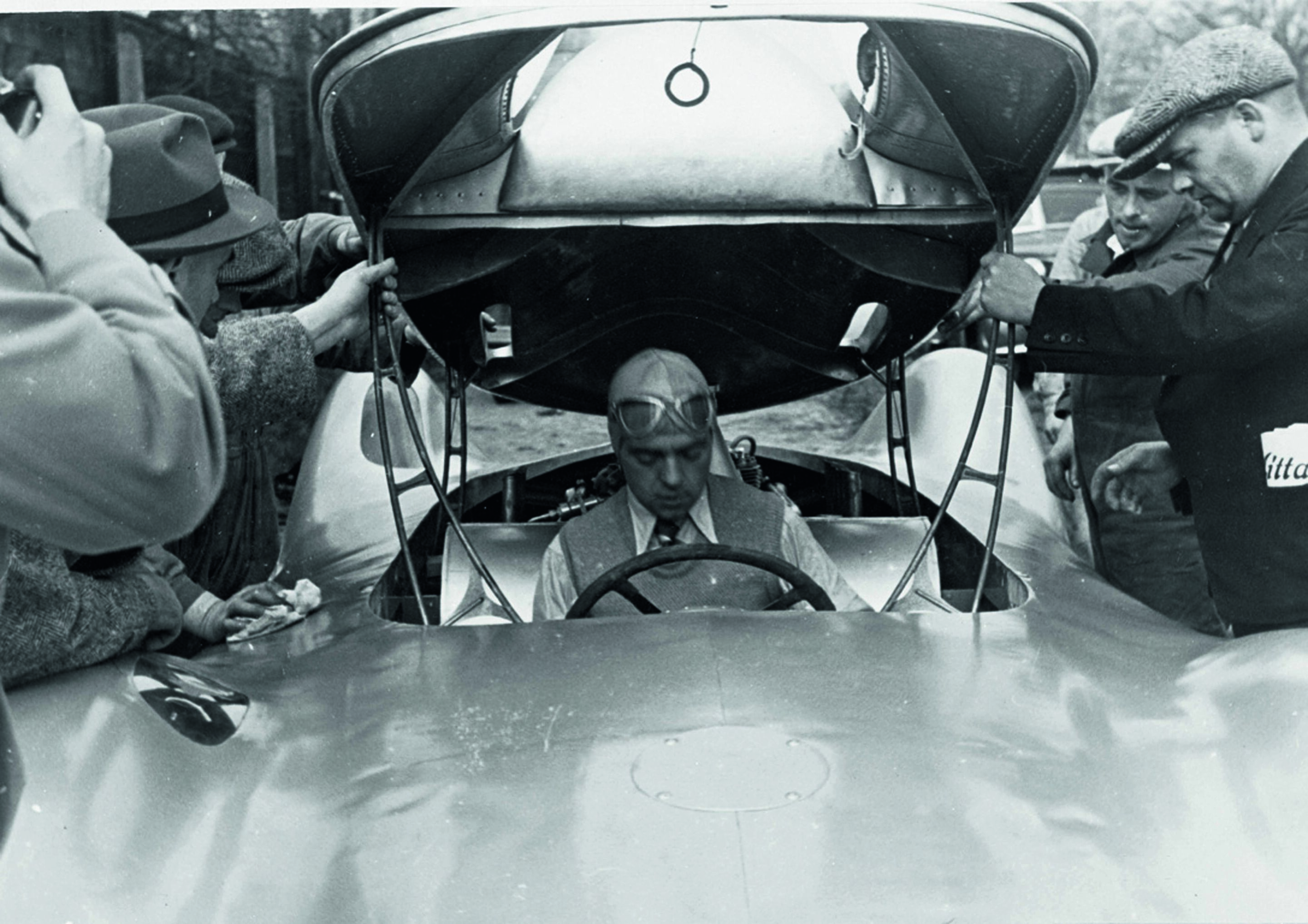 Anniversary magazine Motorsports - Test drive - Rosemeyer with jacket and tie at a test drive on the Berlin Avus in April 1937.