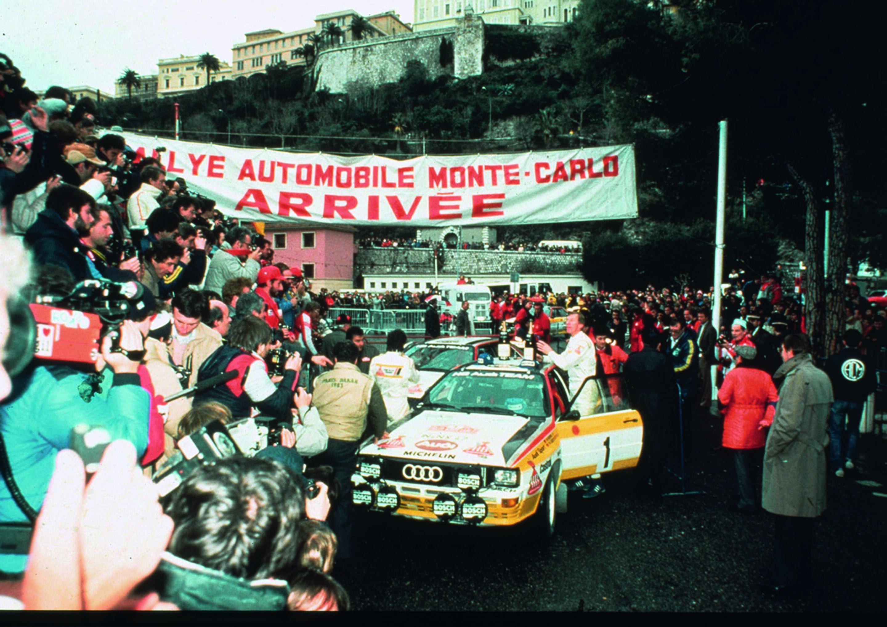 Jubiläumsmagazin Motorsport - Triumph: Röhrl im Ziel der Rallye Monte Carlo 1984. Der "Lange" war 13 Sekunden schneller als Blomqvist.