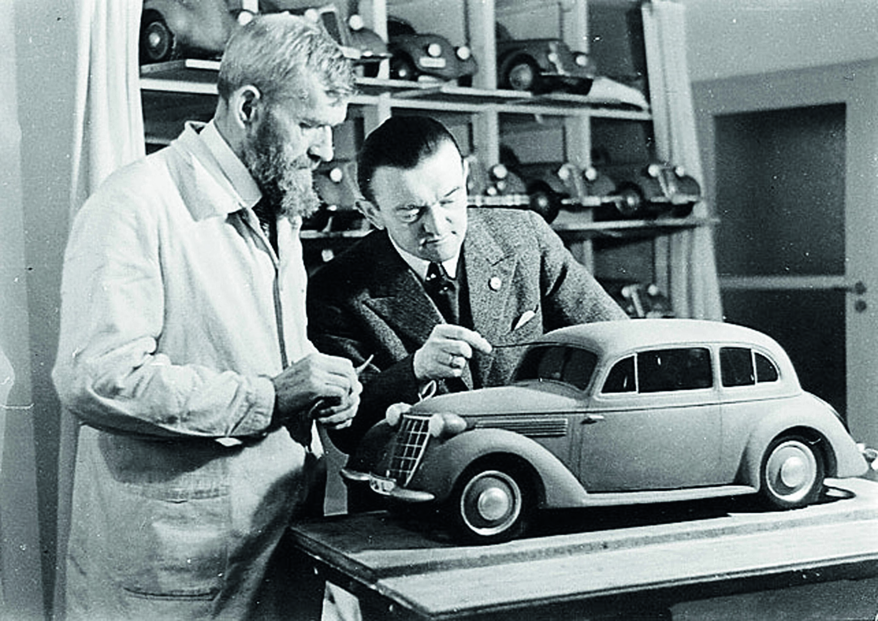 Anniversary magazine Design - Design Center - the Auto Union Technical Director William Werner (right) standig with a model maker beside a clay mock-up.
