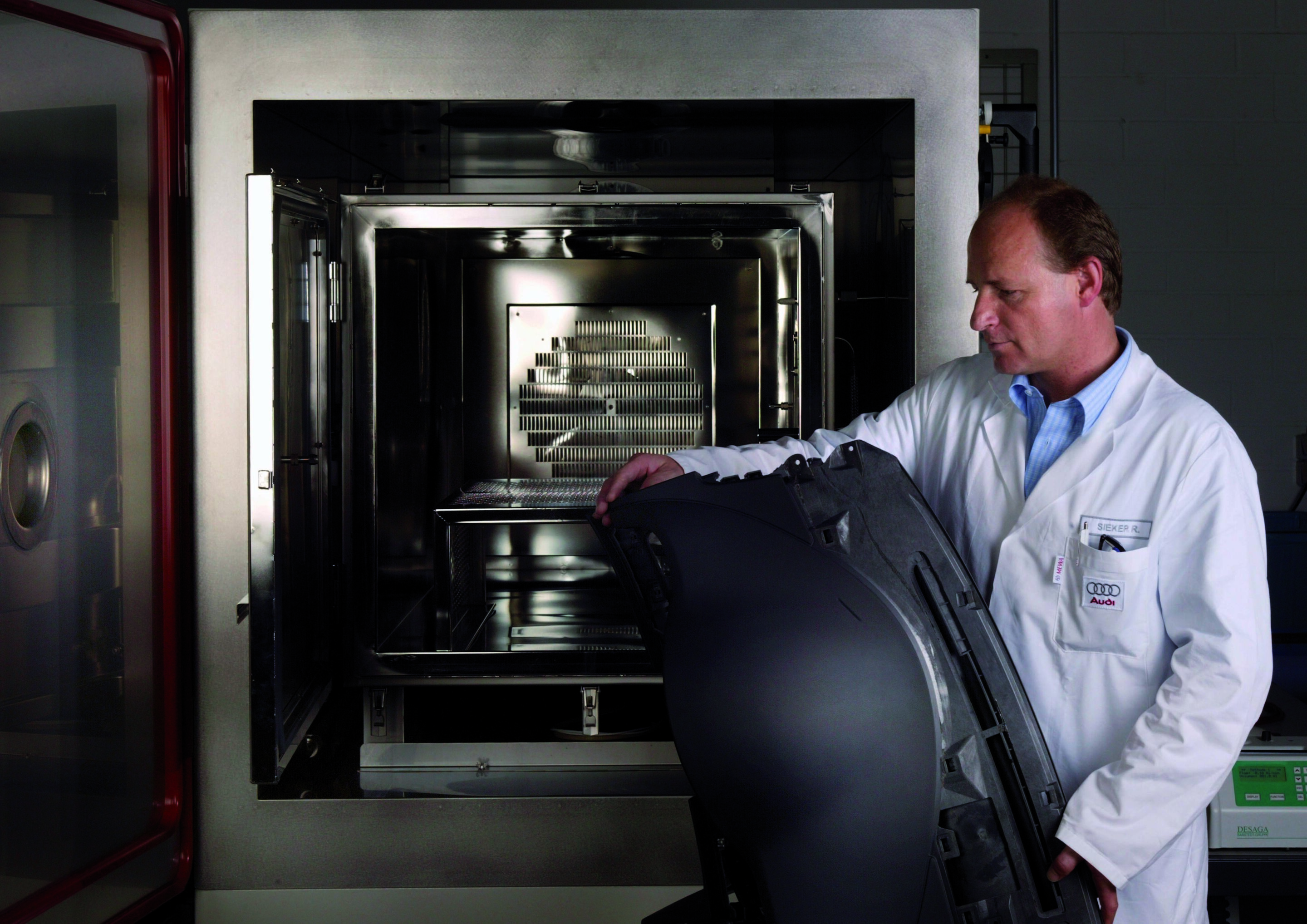 Automotive development with a preserving jar - A member of the Nose Team at the stainless steel oven in which complete components are heated for odour sampling
