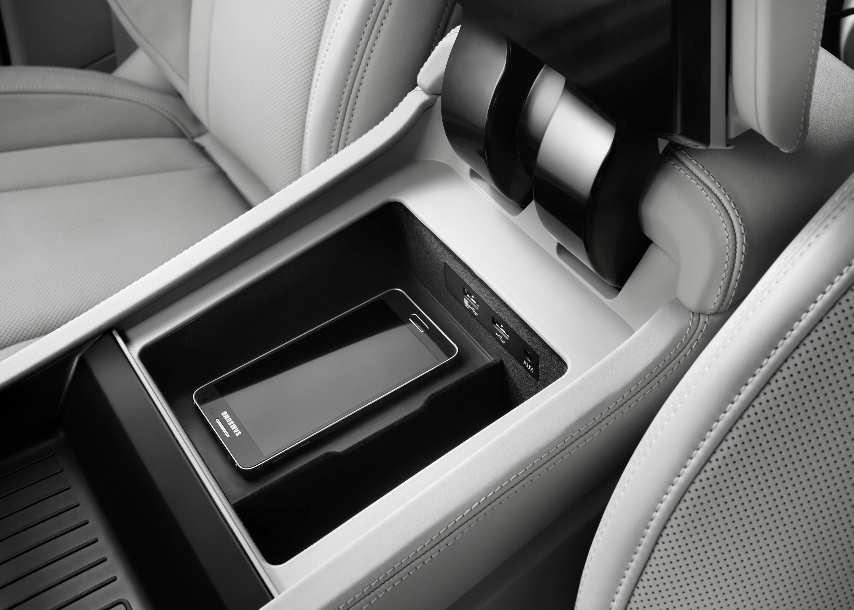 Audi phone box - The Audi phone box in the center armrest connects cell phones to the car antenna wirelessly by near-field coupling and enables inductive charging based on the Qi standard.