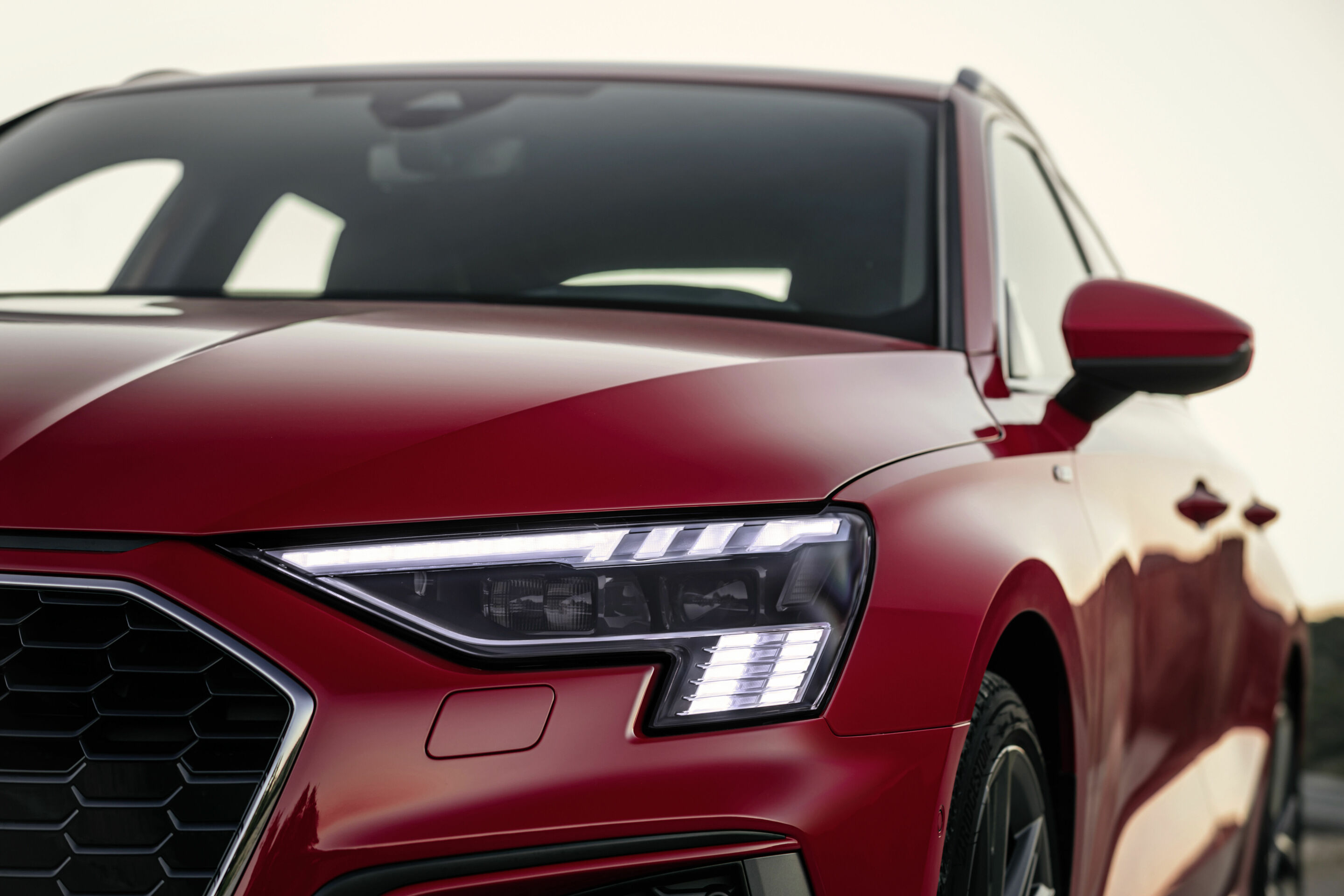 Audi A3 Sportback - Audi A3 Sportback with Matrix LED headlights and digital daytime running lights. Static photo, colour: tango red