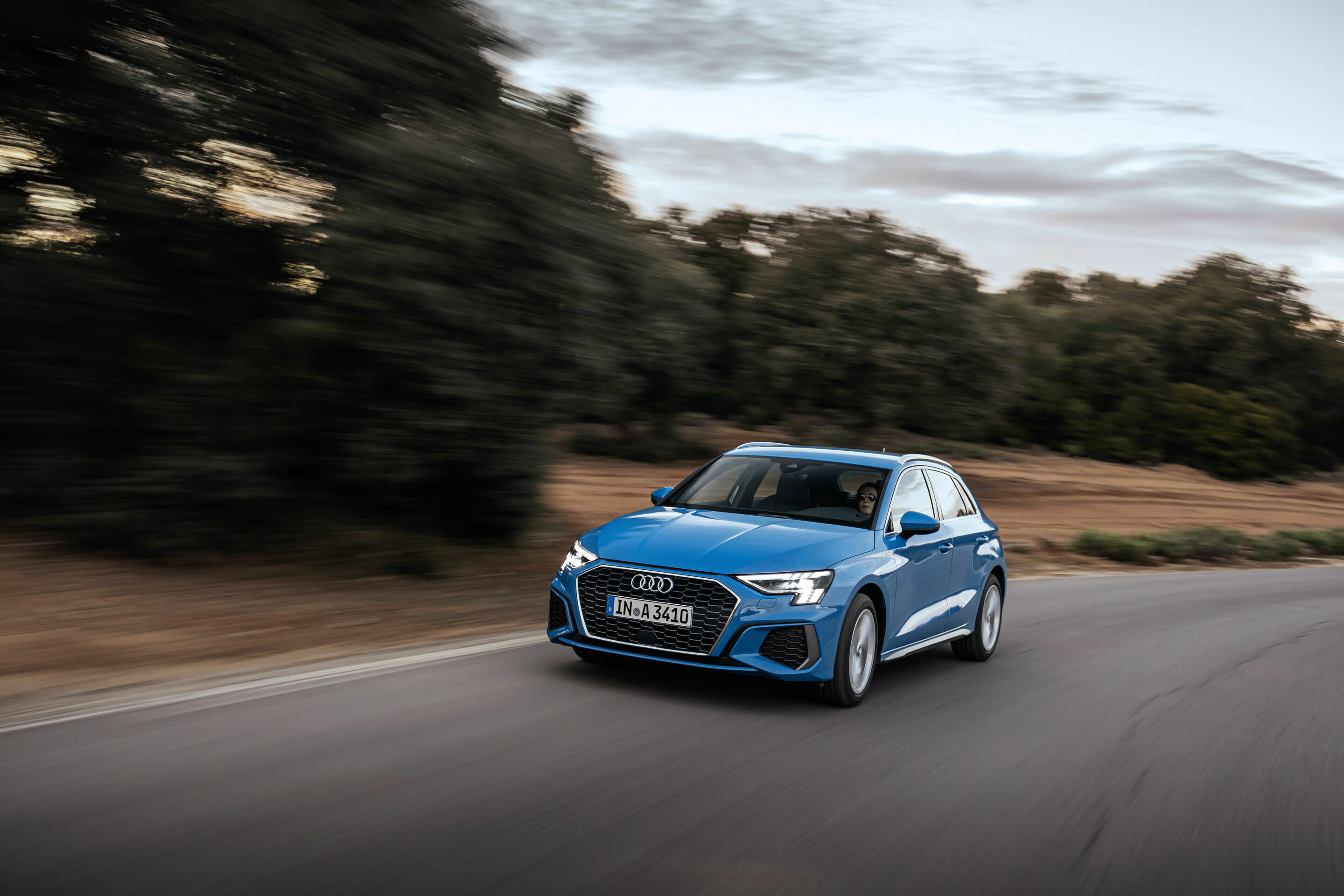 Audi A3 Sportback - Audi A3 with Matrix LED headlights and digital daytime running lights. Dynamic photo, colour: Turbo blue